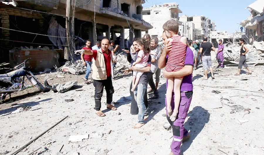 Syrian civilians flee an area targeted by a Russian airstrike on Maaret Al-Numan in Syria's northwestern Idlib province on Monday. (AFP)