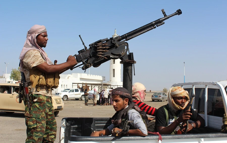Forces loyal to the Saudi-backed Yemeni president stand on the back an armed vehicle on a road. (File/AFP)