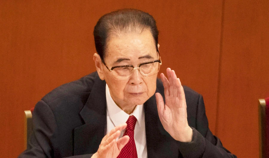 In this Oct. 24, 2017, photo, former Chinese Premier Li Peng, reach for his neck during the closing session of China's 19th Party Congress at the Great Hall of the People in Beijing, China. (AP)