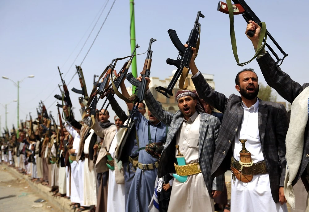The footage showed a corpse being dragged on the ground by his left arm while the armed men chant the Houthi slogan: “Death to America! Death to Israel! Curse the Jews, and victory for Islam.” (File/AFP)