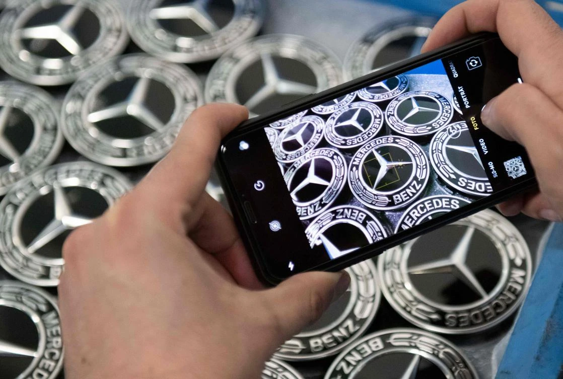 Daimler vows to cut costs after one-offs bring loss