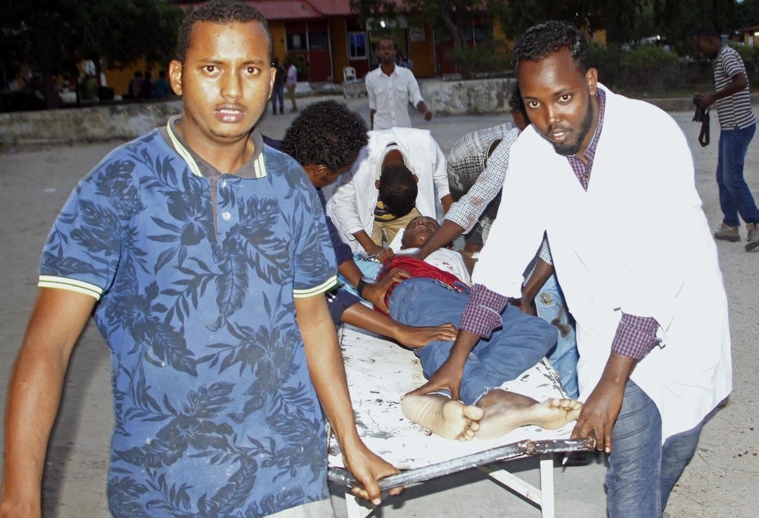 Medical workers help civilian on stretcher who was wounded in suicide bomb, at Madina hospital, Mogadishu, Wednesday, July 24, 2019. A suicide bomber walked into the office of Mogadishu's mayor and detonated explosives strapped to his waist, killing several people and badly wounding the mayor. (AP)