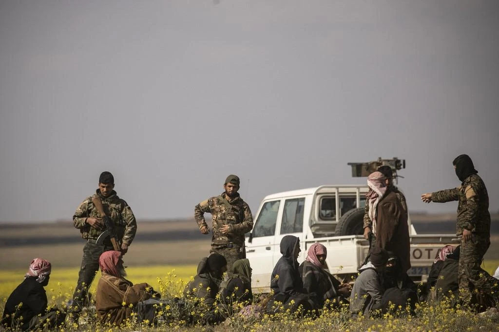 Some of the Daesh wives were dragged into the ME by their husbands. Above, SDF fighters interrogate men suspected of belonging to Daesh. (File/AFP)