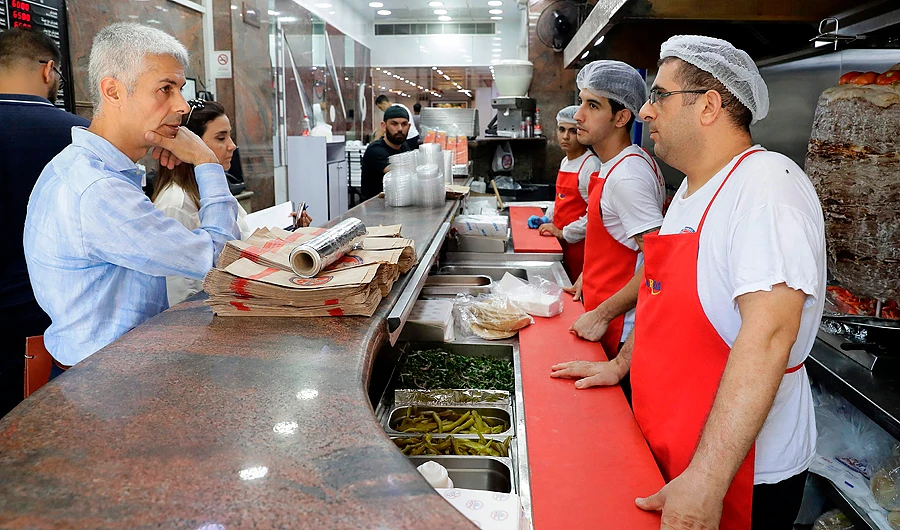 Officials from the Ministry of Labour and the Social Security are pictured at a restaurant in Beirut. (AFP)