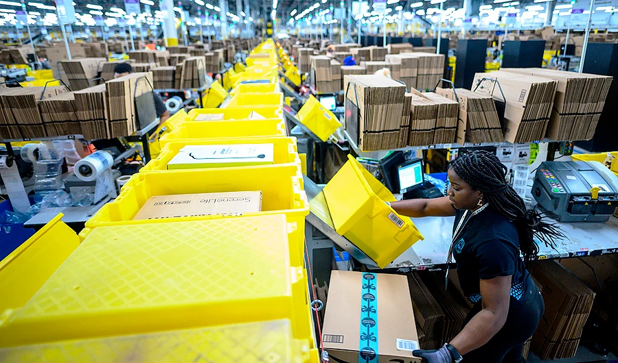 Amazon investing heavily to halve delivery times to one day for Prime members, to stay ahead of rivals. (AFP)