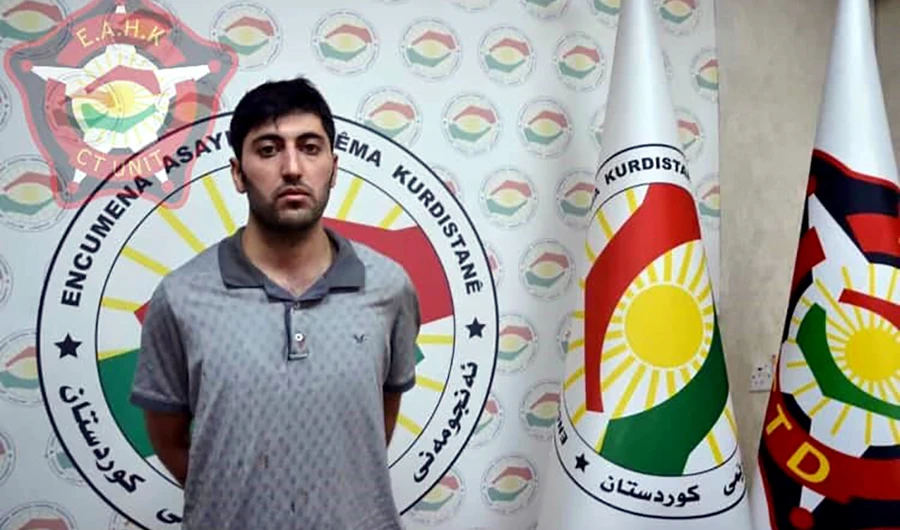 A 27-year-old Mazloum Dag, Kurdish man from Turkey who was identified as the suspected shooter in the murder of a Turkish diplomat, standing at an undisclosed location in Erbil. (AFP)