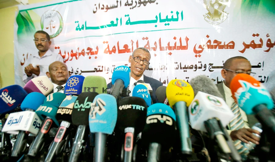Sudanese head of the probe committee Fath Al-Rahman Saeed, center, briefs the media about the killing of demonstrators in Khartoum on Saturday. (AFP)