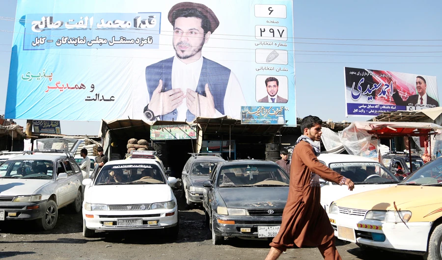 A campaign poster of the parliamentary election is displayed over the shops in Kabul, Afghanistan, in this Oct. 9, 2018 file photo. (AP)