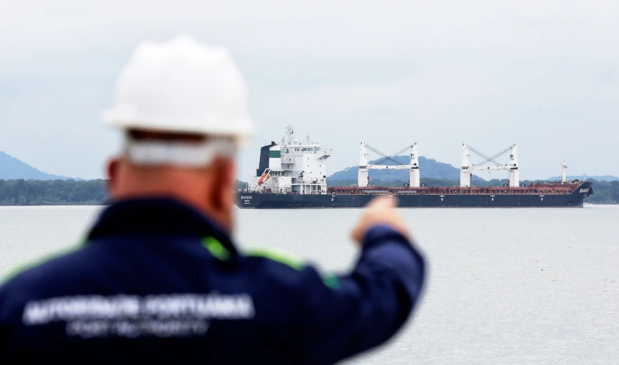 A Port Authority officer points at the Bavand, one of two stranded Iranian vessels, anchored at the port in Paranagua, Brazil, Thursday, July 25, 2019. (AP)