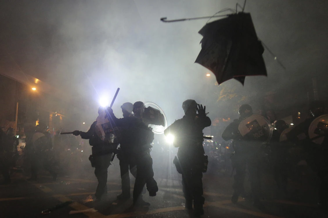 Hong Kong police launched tear gas at protesters Sunday after a massive pro-democracy march continued late into the evening. (Andy Lo/HK01/AP)