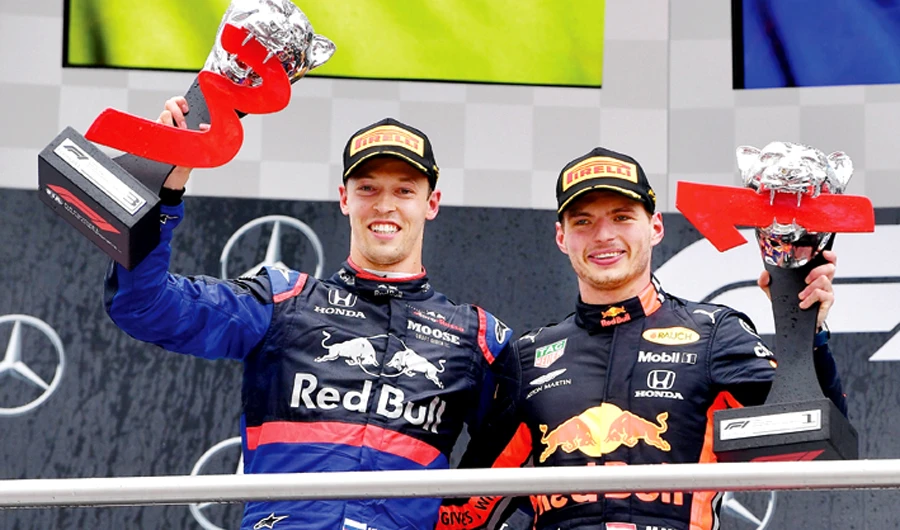 Red Bull’s Dutch driver Max Verstappen, right, and third placed Toro Rosso’s Russian driver Daniil Kvyat with their trophies on the podium. (AFP)