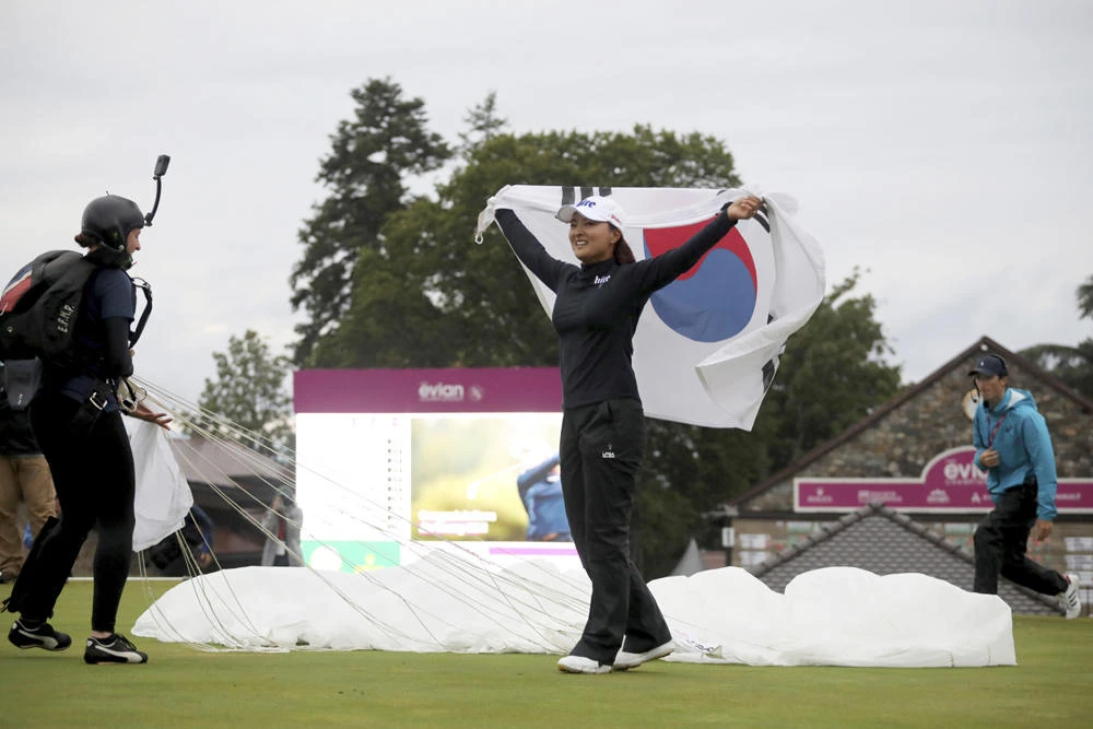 South Korea's Ko Jin-young celebrates with a South Korean flag after winning the Evian Championship women's golf tournament in Evian, eastern France,on July 28, 2019. Ko won the championship by two shots with score of -15. (AP Photo/Laurent Cipriani)