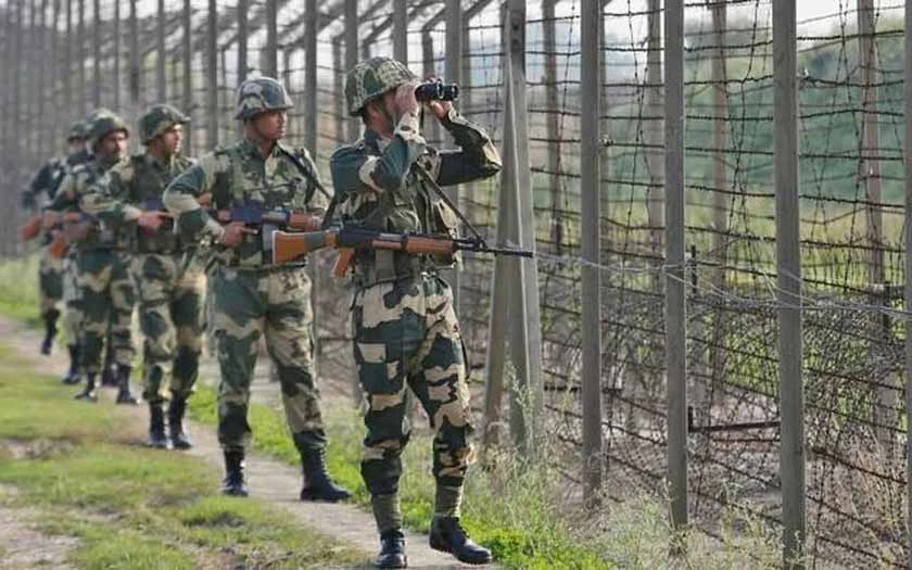 India Border Security Force (BSF) soldiers patrol along the fenced border with Pakistan in Ranbir Singh Pura sector near Jammu. (Reuters)