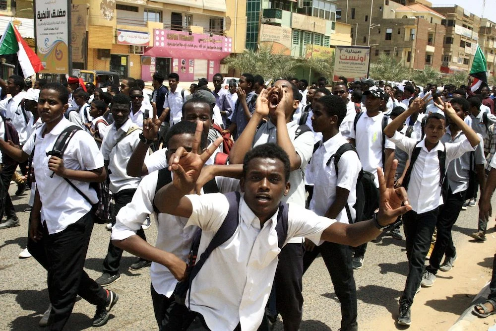 Sudanese students protest in the capital Khartoum on Tuesday, a day after teenagers were shot at a rally against shortages of bread and fuel in the town of Al-Obeid. (AFP)