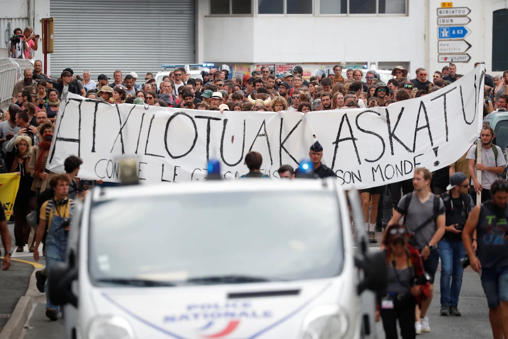Anti-G7 protesters are surrounded by police during a demonstration in Hendaye, near Biarritz, as part of the G7 summit, France, Aug. 25, 2019. (Reuters)