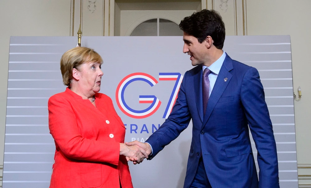Canadian Prime Minister Justin Trudeau takes part in a bilateral meeting with German Chancellor Angela Merkel during the G7 Summit in Biarritz, France on Sunday, Aug. 25, 2019. (The Canadian Press via AP)