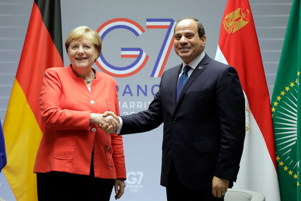 German Chancellor Angela Merkel shakes hands with Egyptian President Abdel-Fattah El-Sisi during a meeting on the second day of the G-7 Summit in Biarritz, France Sunday, Aug. 25, 2019. (AP)
