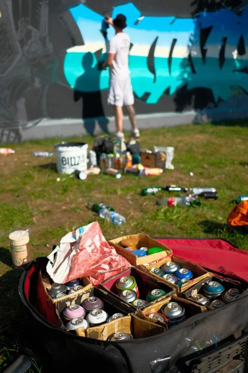 Artists spray Graffiti on a wall in the harbor in Bremerhaven, northern Germany, on August 24, 2019. Every year Graffiti artist can paint a wall on a factory building on a length of 400 meter. / AFP / PATRIK STOLLARZ