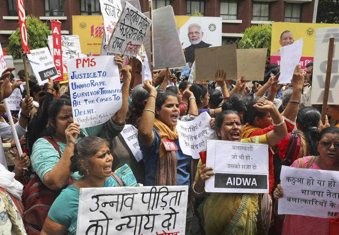 Women activists shout slogans during a protest demanding a fast-track probe into a highway accident that critically injured a woman who has accused a ruling BJP lawmaker of rape that led to his arrest last year, outside Uttar Pradesh House in New Delhi, India, Tuesday, July 30, 2019. (AP)