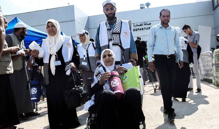 Palestinian Muslim pilgrims arrive at the Rafah border crossing between Egypt and the southern Gaza Strip, on August 14, 2017, ahead of their departure to the annual Hajj pilgrimage in Saudi Arabia's holy city of Makkah. (AFP)