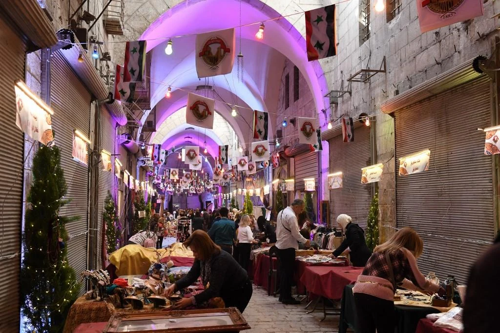 Syrians preparing merchandise to be sold during the opening of Aleppo’s historic souk in 2017. (File/AFP)
