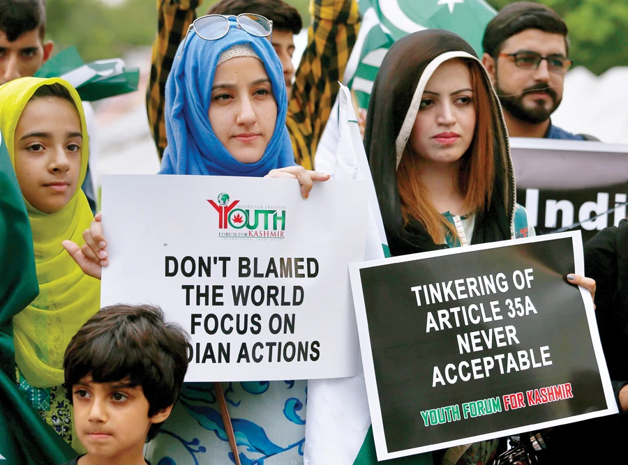 Members of the Youth Forum for Kashmir, a civil society group, protest against India’s policy on Kashmir in Islamabad. (AP)