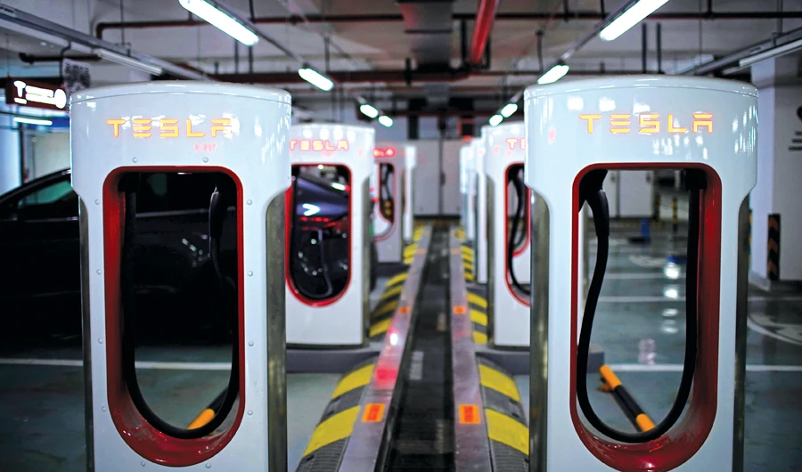 Tesla superchargers in a parking lot in Suzhou, China, where the car maker is mulling price rises amid yuan-related uncertainty. (Reuters)