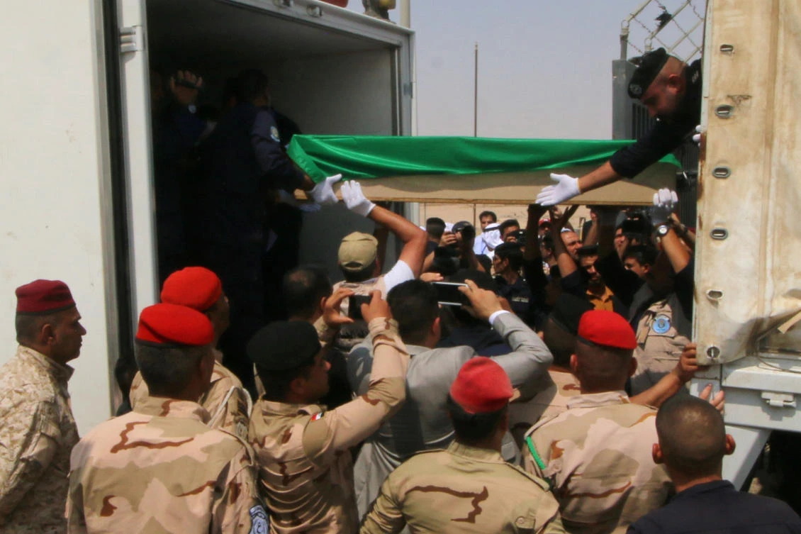 Iraqi soldiers hand over the remains of dozens of Kuwaiti citizens missing since the first Gulf war to Kuwaiti policemen in Basra, Iraq August 8, 2019. (Reuters)