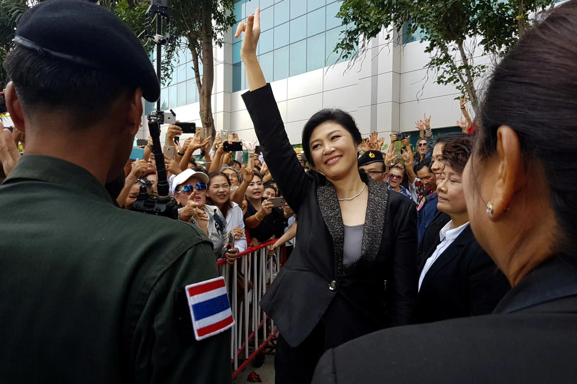 Ousted former Thai prime minister Yingluck Shinawatra greets supporters as she leaves the Supreme Court in Bangkok, Thailand, in 2017. (Reuters)