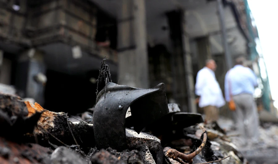 Belongings of victims are seen amid rubble in front of the damaged facade of the National Cancer Institute after an overnight fire from a blast, in Cairo, Egypt. (Reuters)