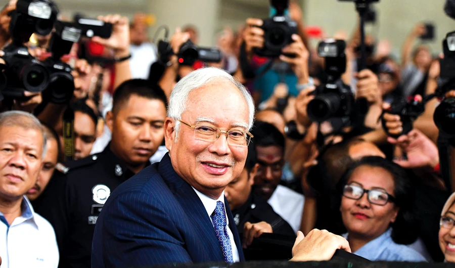 Malaysia’s former Prime Minister Najib Razak leaves a court in Kuala Lumpur after his trial over alleged involvement related to 1MDB. (AFP)