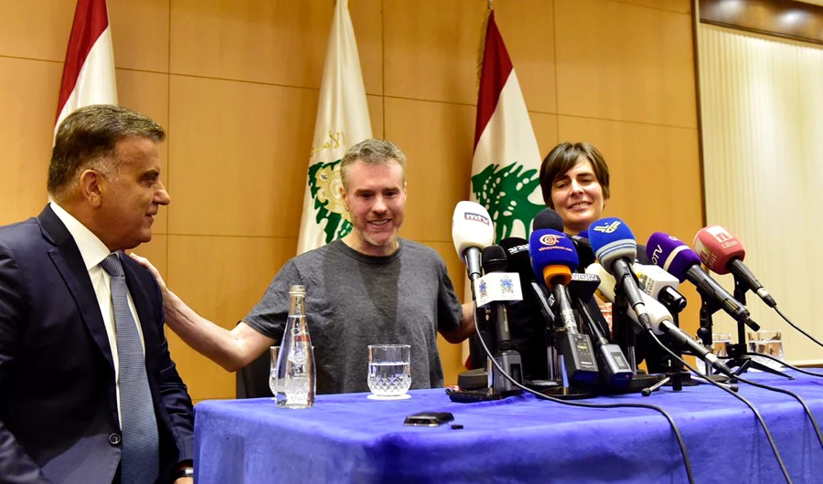 Maj. Gen. Abbas Ibrahim, left, Lebanon's General Security Chief, speaks with Canadian citizen Kristian Lee Baxter, center, who was released from Syrian prisons to Lebanon, during a press conference in Beirut, Lebanon, on Friday. (Photo/Supplied)