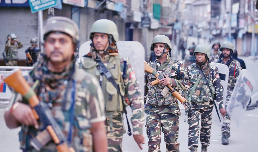 Indian security forces patrol a deserted street in Srinagar on Friday. (Reuters)