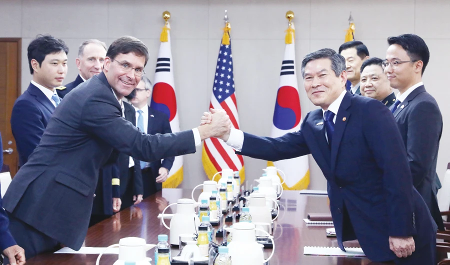 US Defense Secretary Mark Esper clasps hands with South Korean Defense Minister Jeong Kyeong-doo during their meeting in Seoul. (Reuters)