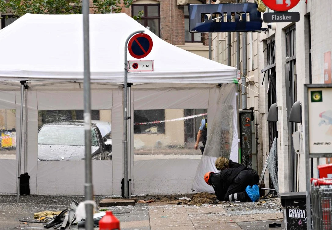 Danish police forensics experts work on Hermodsgade outside a local police station in Copenhagen on Aug. 10, after the police station was hit by an explosion in the early morning. (AFP)