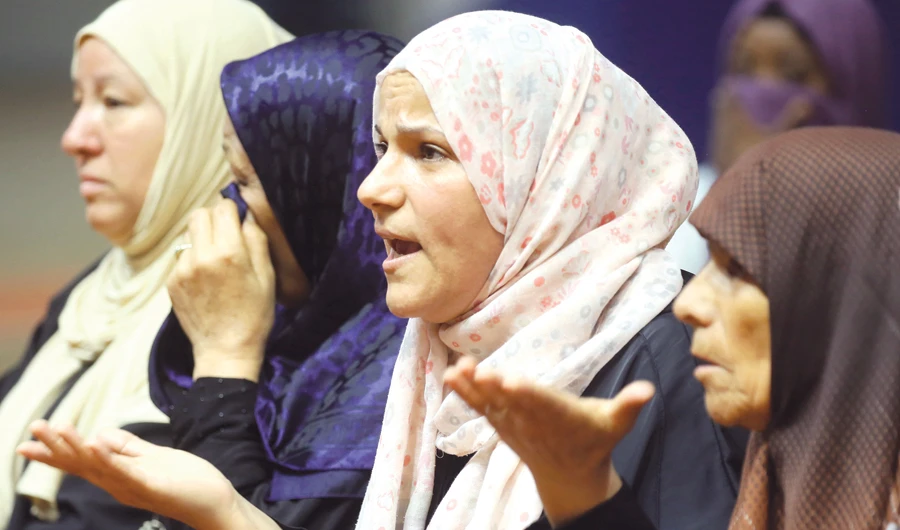 Libyan women react at a meeting with charity workers at a gym in Tripoli. (AFP)