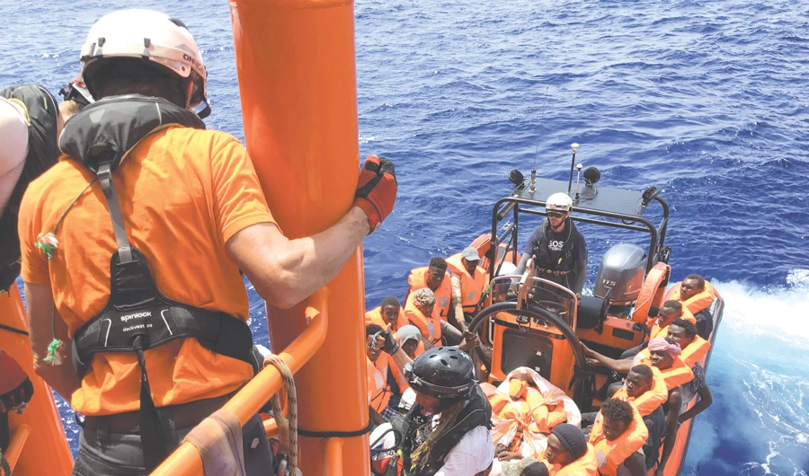 Crew members of the ‘Ocean Viking’ rescue ship, operated by French NGOs SOS Mediterranee and MSF, arrive with rescued migrants on board of a ‘rhib,’ before boarding the rescue vessel on Saturday, following their second rescue operation in the Mediterranean Sea. (AFP)