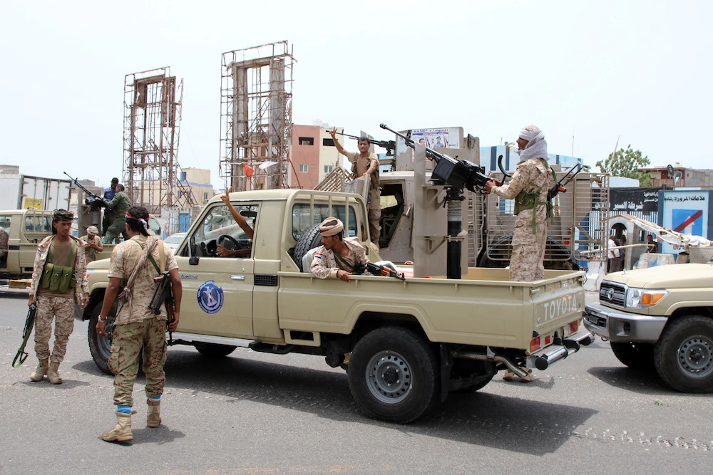 Members of the southern Yemeni separatist forces patrol a road during clashes with government forces in Aden Saturday. (Reuters)