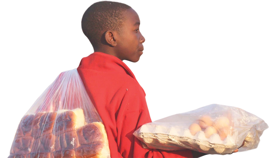 A young boy sells boiled eggs and buns on the streets of Harare. (AP)