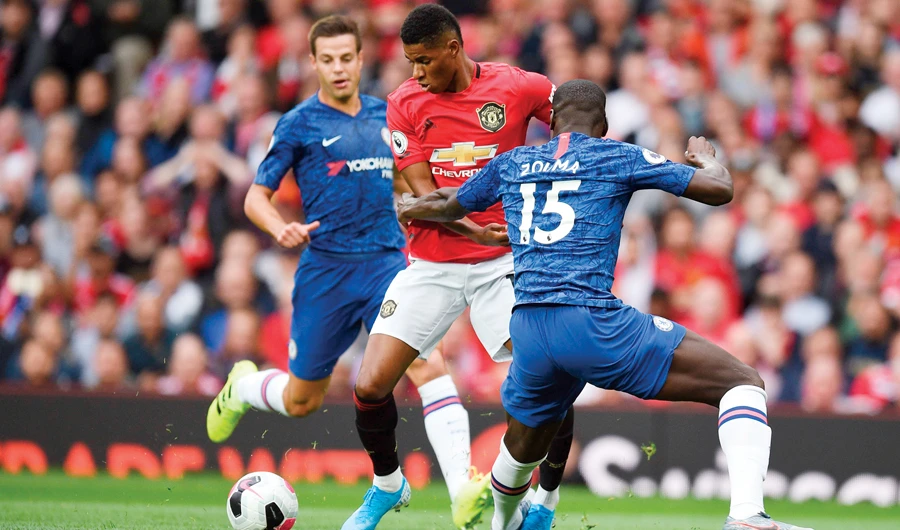 Manchester United’s Marcus Rashford, center, is fouled by Chelsea’s Kurt Zouma, right, to concede a penalty leading to the opening goal. (AFP)