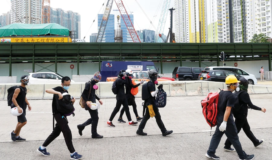 Anti-extradition bill protesters walk through Sham Shui Po neighborhood in Hong Kong. (Reuters)