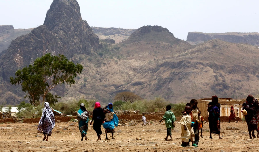 Sudanese villagers walk in the war-torn town of Golo in central Darfur. (AFP/File)