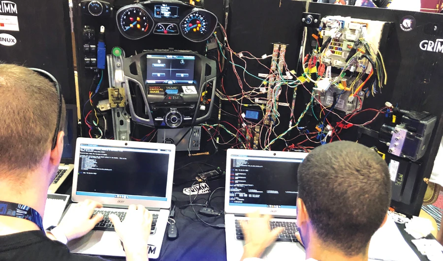 Attendees of the cybersecurity event test their skills at the conference’s car hacking village in Las Vegas. (Reuters)