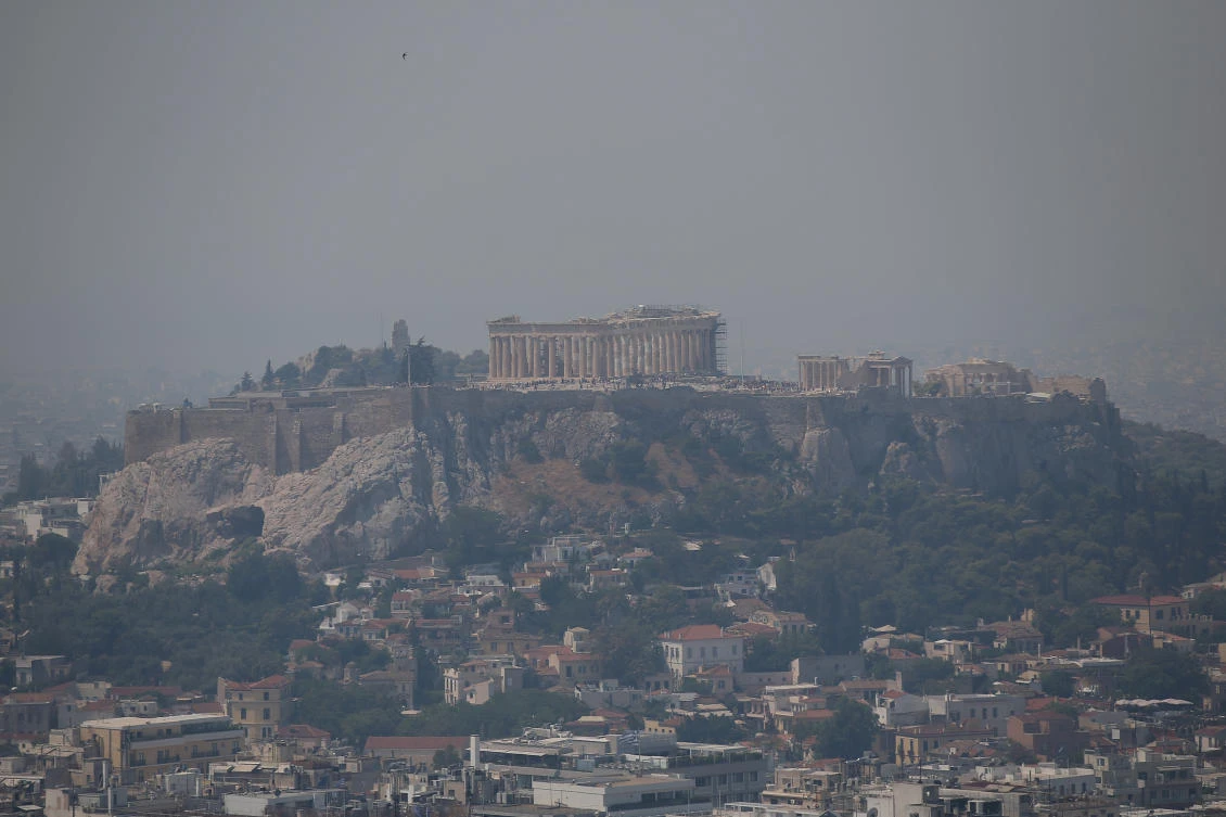 The Acropolis and the Parthenon, in Athens, are covered in smoke from a wildfire burning on nearby Evia island. (Reuters)