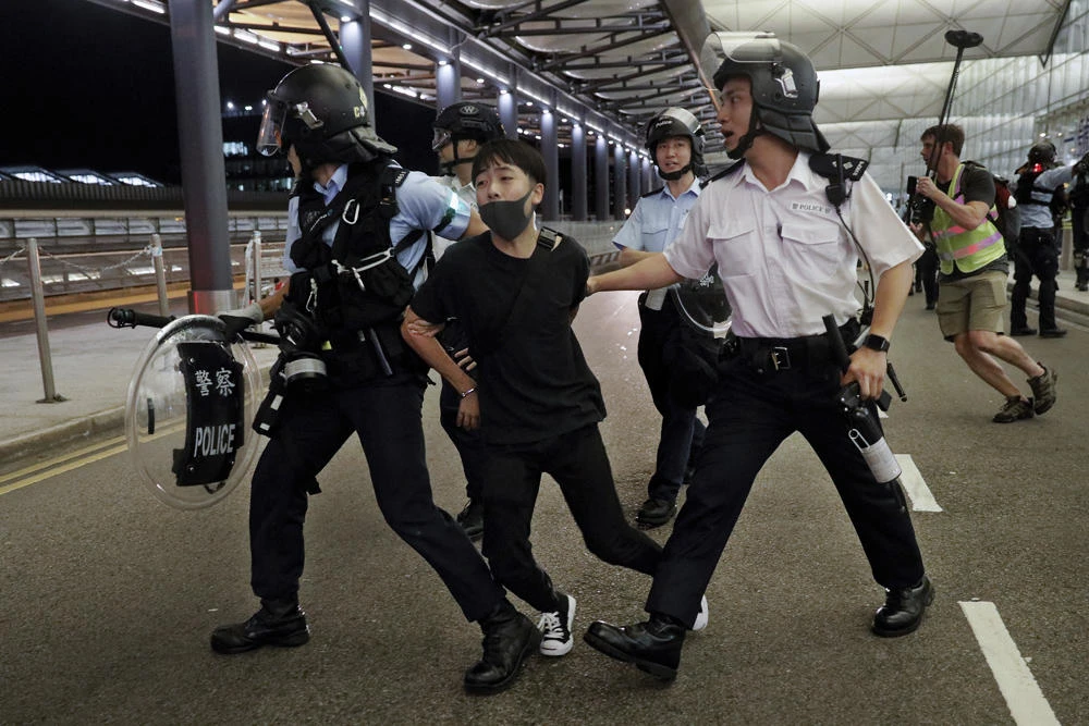 Policemen arrest a protester during a clash at the Airport in Hong Kong on Aug. 13, 2019. (AP Photo/Vincent Yu)