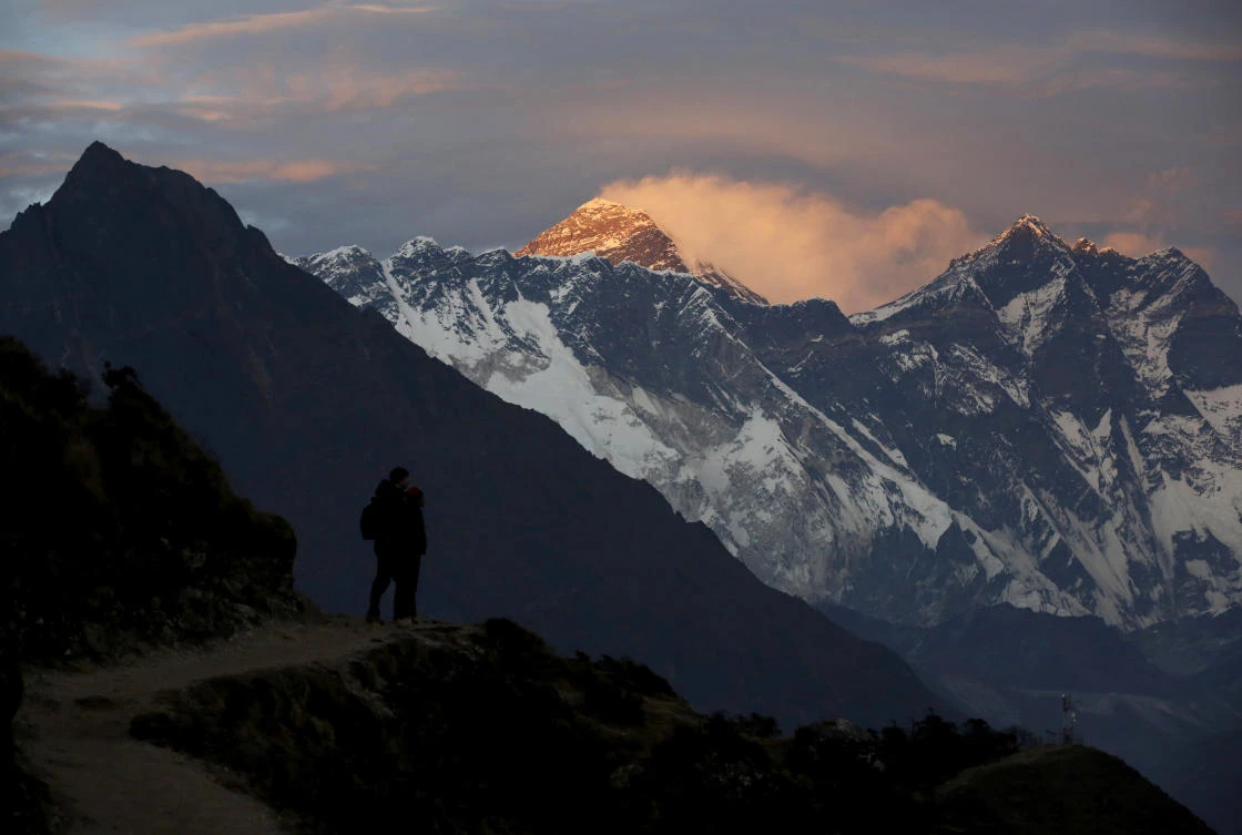 Light illuminates Mount Everest, center, during sunset in Solukhumbu district, also known as the Everest region. (Reuters)