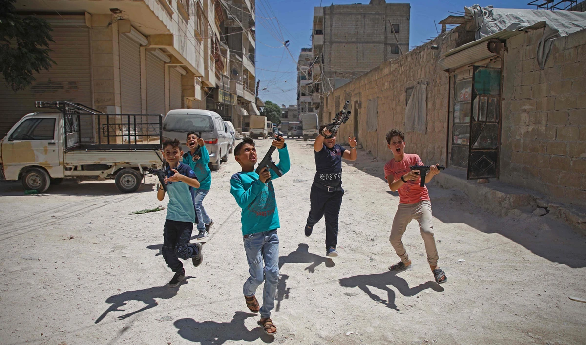 Syrian boys play with plastic guns on the first day of the Muslim religious festival of Eid al-Adha in al-Dana in Syria's rebel-controlled Idlib region, near the border with Turkey, on August 11, 2019. (AFP)