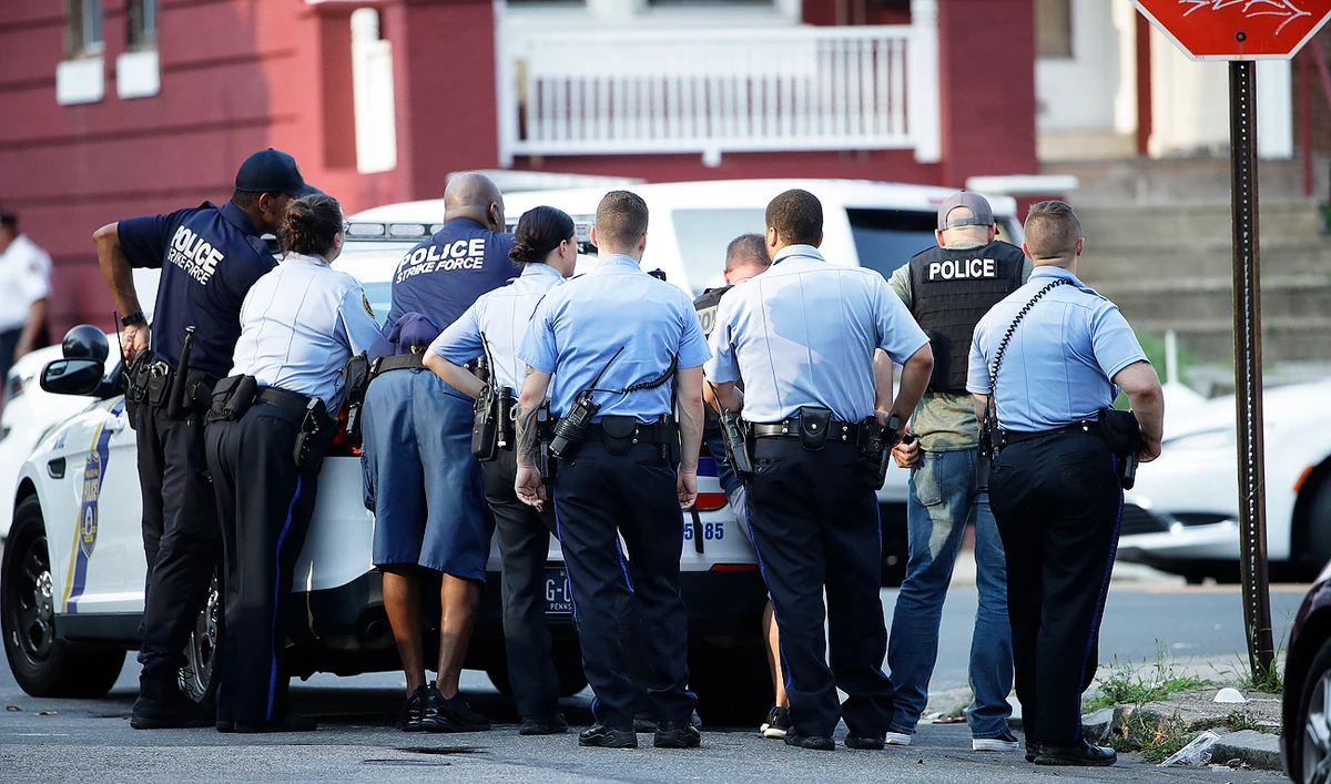 Philadelphia police take cover as they respond to an active shooting situation. (AP)