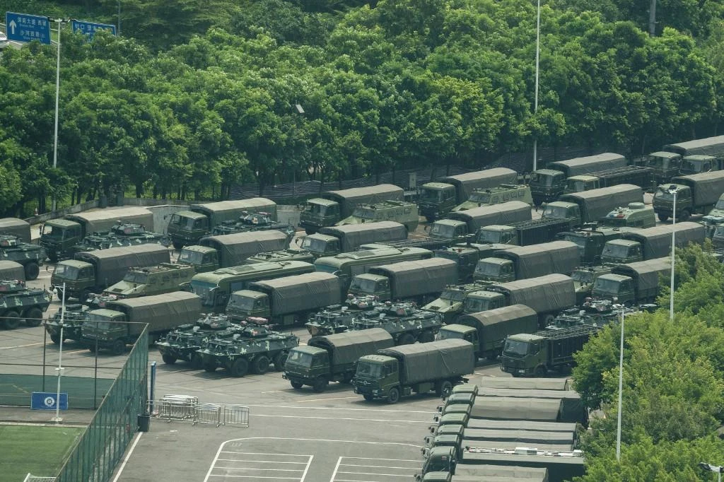 Trucks and armoured personnel carriers are seen outside the Shenzhen Bay stadium in Shenzhen, bordering Hong Kong in China’s southern Guangdong province on August 15, 2019. (AFP)