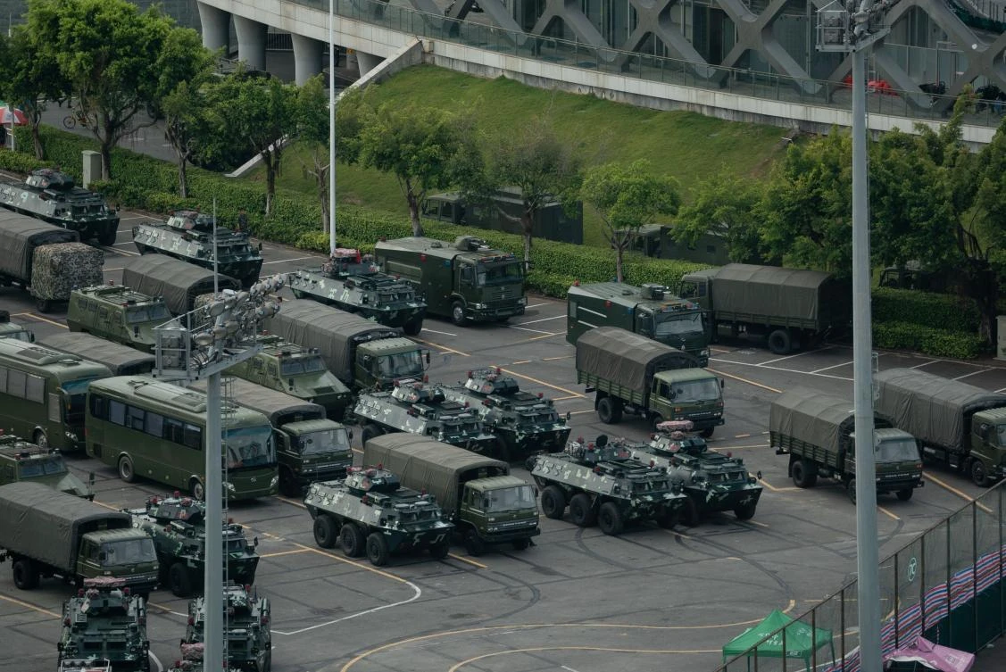 Trucks and armored personnel carriers are parked at the Shenzhen Bay stadium in Shenzhen, bordering Hong Kong in China’s southern Guangdong province. (AFP)